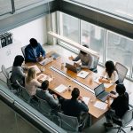 Equipo reunido en una sala de reuniones corporativa, intercambiando ideas y analizando estrategias de negocio